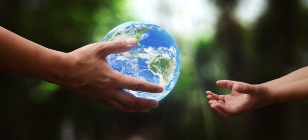 concept - hands of adult giving planet earth to child - elements